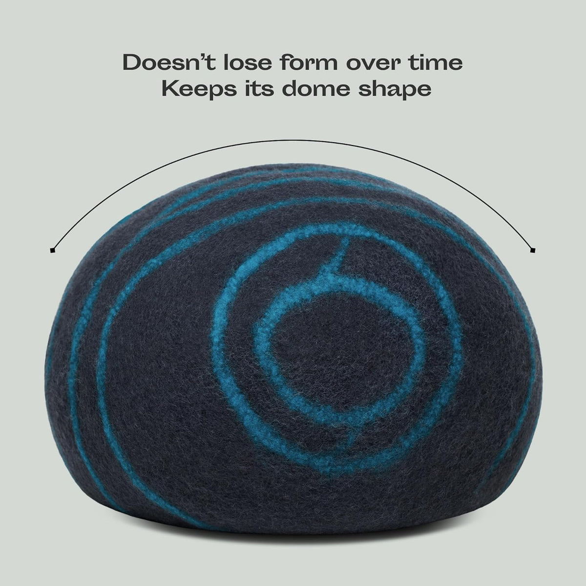 Aqua and black dome-shaped pillow with text on a light gray background