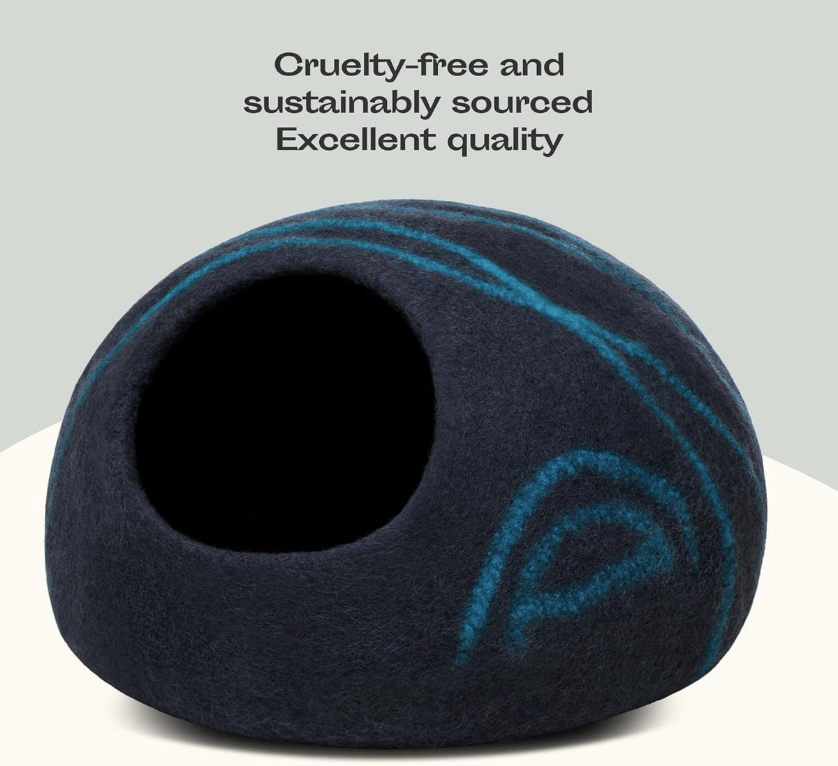 Black pet bed with blue accents on a white surface, labeled as cruelty-free and sustainably sourced.