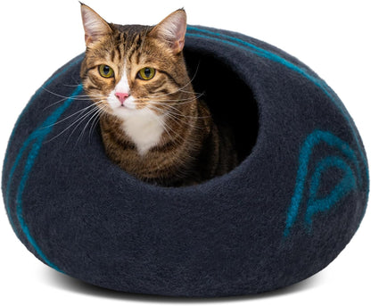 Cat inside a dark blue felted pet bed with a visible brand logo on a white background