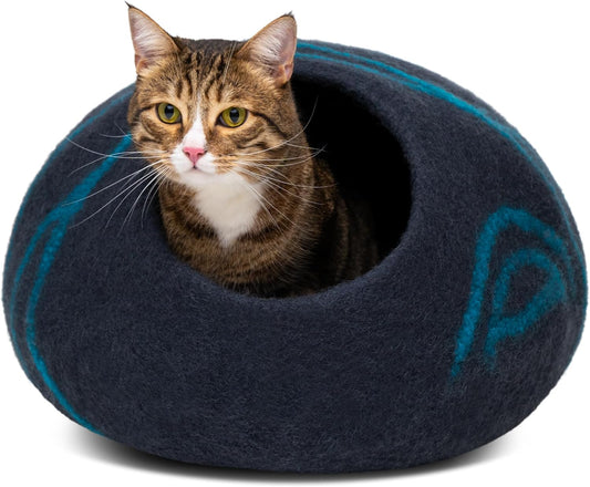 Cat inside a dark blue felted pet bed with a visible brand logo on a white background